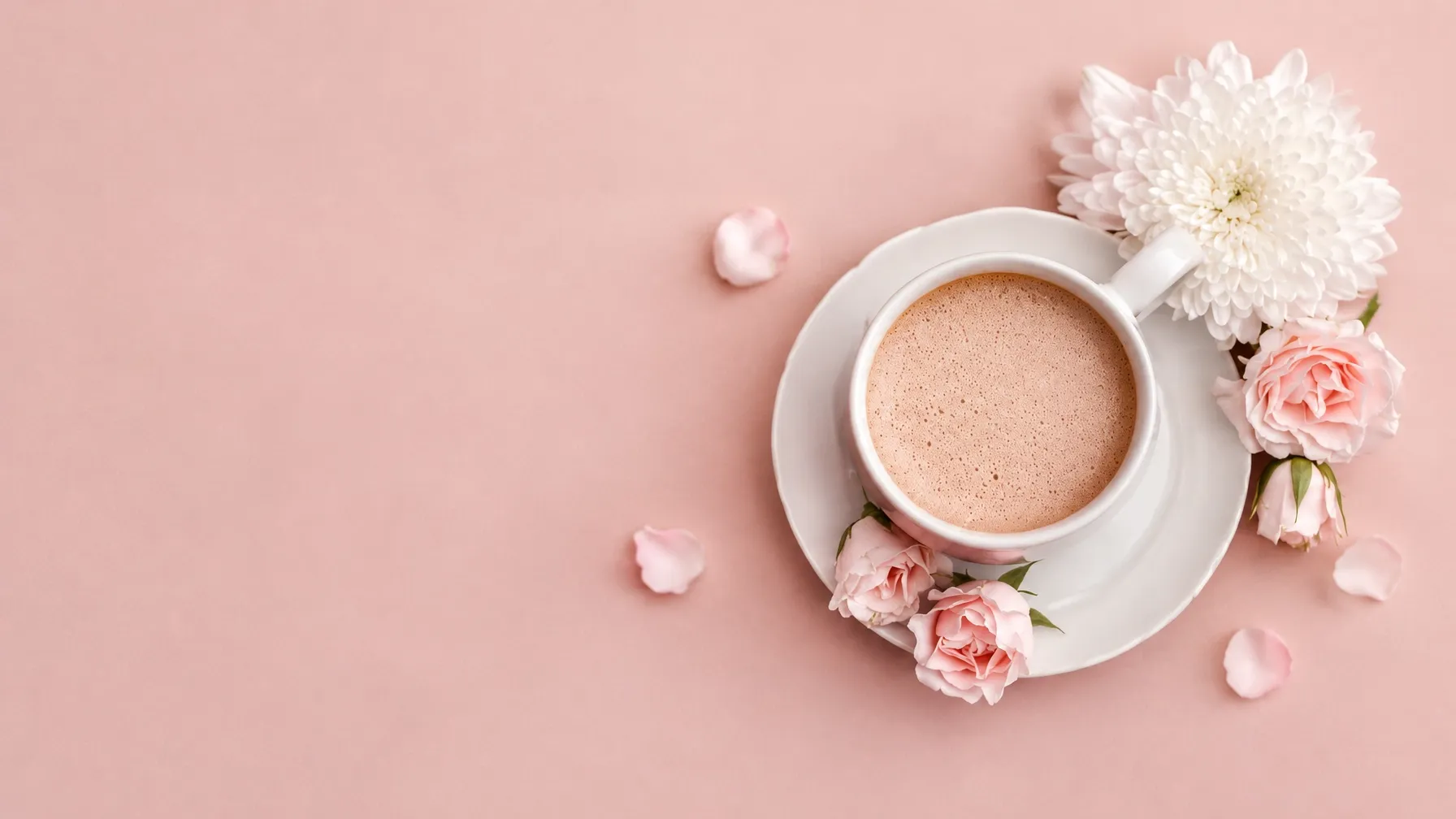 Coffee and flowers arranged on a blush pink brunch table